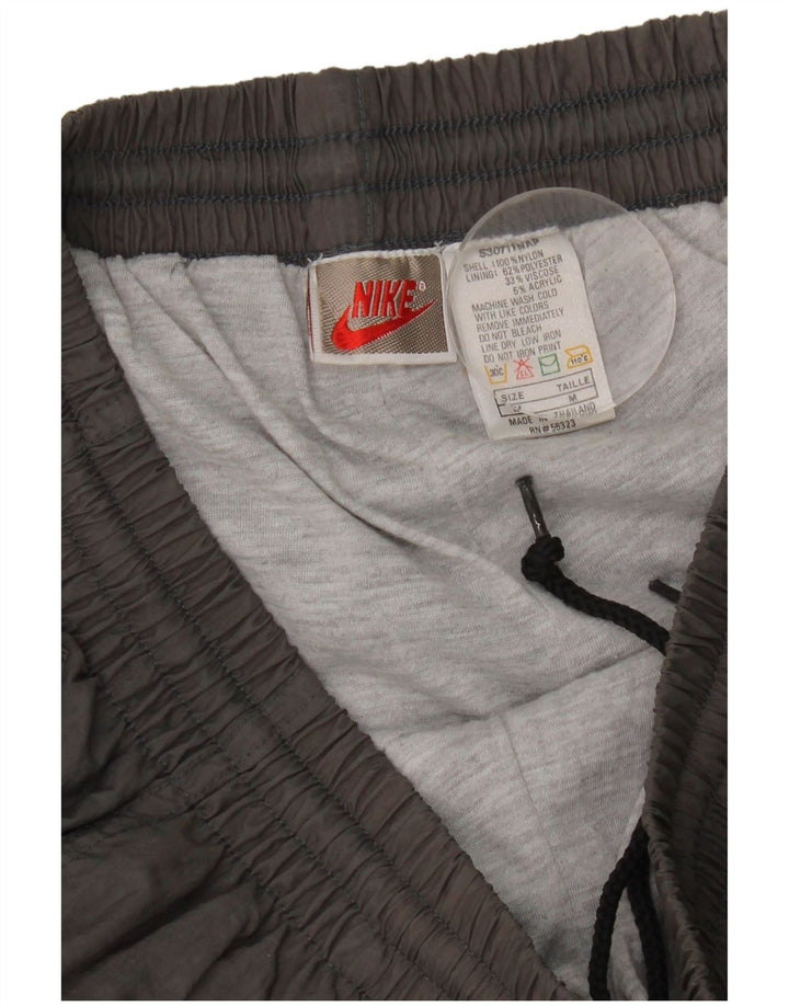 Pantalon de survêtement Nike Homme Pantalon de jogging en nylon gris moyen