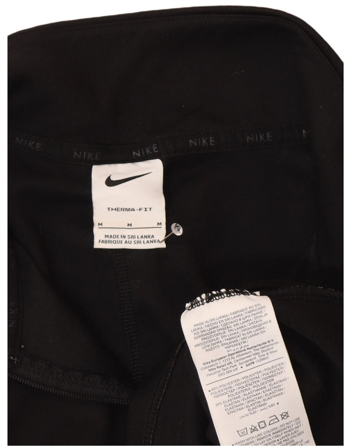 Nike Haut de survêtement à col zippé Therma-Fit pour femme UK 14 Noir moyen