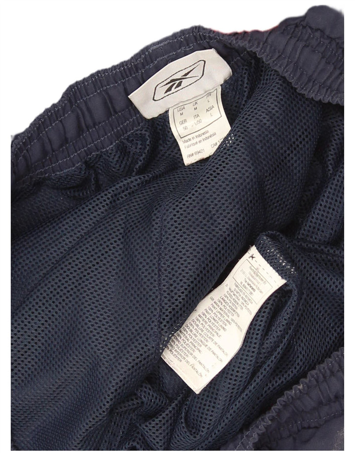 Reebok Pantalon de Survêtement Graphic Homme Bleu Marine Colorblock