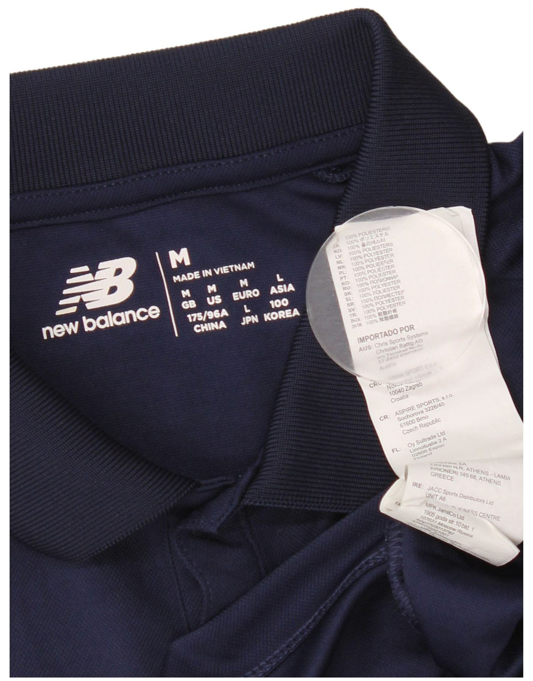 New Balance Polo Graphique Homme Bleu Marine Moyen Polyester